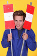 Man holding two metal road signs