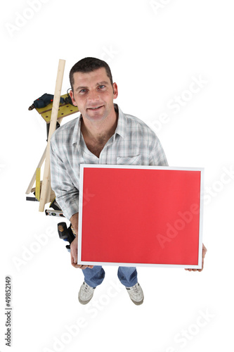 Photo: Laborer with red sign isolated on white background Laborer with red sign isolated on white background