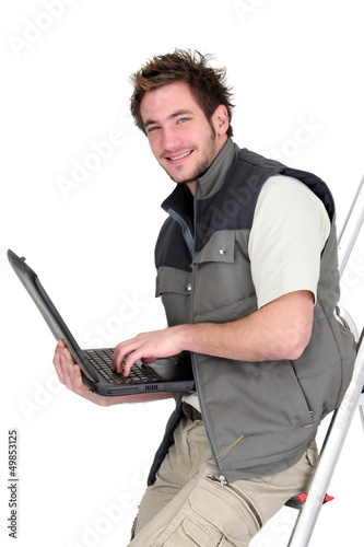 Photo: Tiler perched on step-ladder Tiler perched on step-ladder