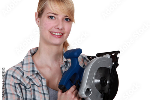 Photo: Woman holding circular saw Woman holding circular saw