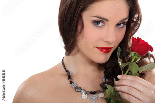 Photo: Woman holding a red rose Woman holding a red rose