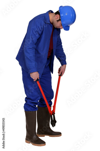 Photo: Man using bolt cutters Man using bolt cutters