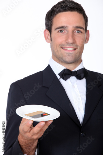 Photo: Waiter with a customer's credit card Waiter with a customer's credit card