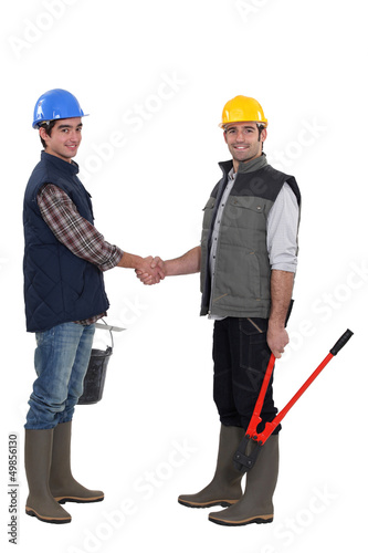 Photo: Construction workers handshaking Construction workers handshaking