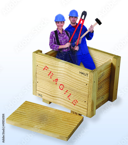 Photo: female and male construction workers in wooden box female and male construction workers in wooden box