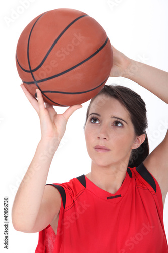Photo: Girl throwing basketball Girl throwing basketball