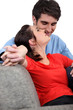 charming couple of newlyweds on sofa