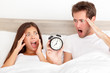 Oversleeping - horrified couple have overslept