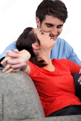 Photo: charming couple of newlyweds on sofa charming couple of newlyweds on sofa