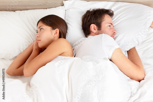 Photo: Upset couple with marital problems in bed Upset couple with marital problems in bed