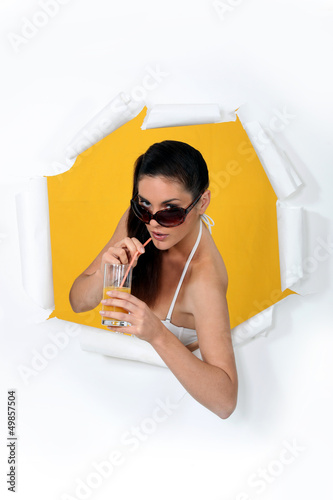 Photo: a woman drinking orange juice a woman drinking orange juice