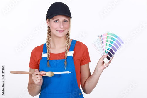 Photo: young female painter holding color chart young female painter holding color chart