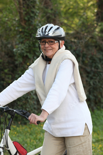 Photo: Elderly woman out riding her bike Elderly woman out riding her bike