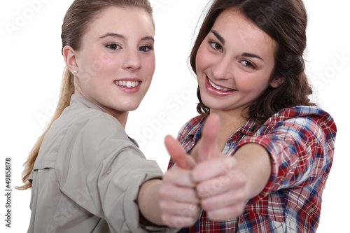 Photo: Two teenage girls giving the thumbs-up Two teenage girls giving the thumbs-up