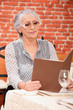 Woman reading menu in restaurant