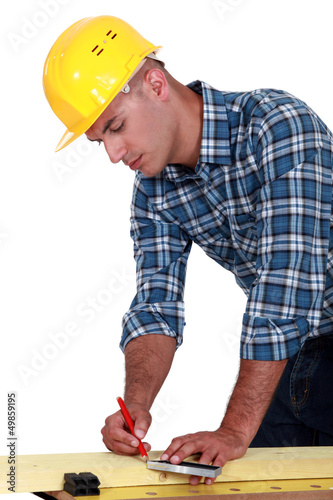 Photo: A carpenter taking measures. A carpenter taking measures.