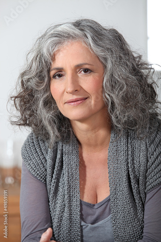 Photo: Grey-haired lady sat at home alone Grey-haired lady sat at home alone