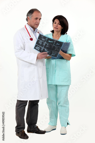 Photo: Doctor and nurse looking at x-ray Doctor and nurse looking at x-ray