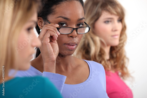 Photo: Three woman in a row. Three woman in a row.