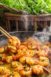 Hot shrimp fried in a pan with butter and herbs