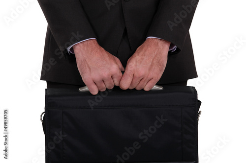 Photo: Businessman holding his briefcase Businessman holding his briefcase