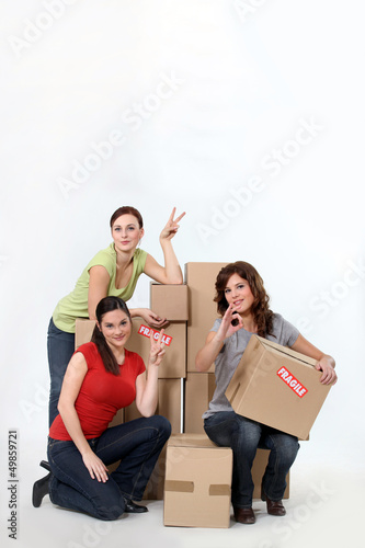Photo: trio of female students moving in together trio of female students moving in together