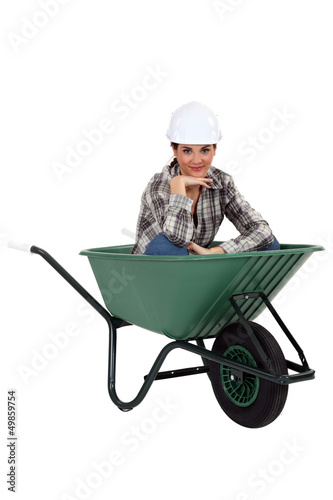 Photo: Tradeswoman sitting in a wheelbarrow Tradeswoman sitting in a wheelbarrow
