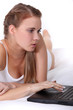 Woman in underwear using laptop