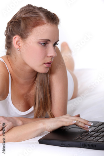 Photo: Woman in underwear using laptop Woman in underwear using laptop