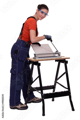 Photo: Woman cutting tiles Woman cutting tiles