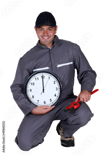 Photo: Tradesman holding a clock Tradesman holding a clock