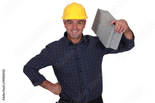 Photo: mason holding brick mason holding brick