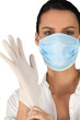 young nurse putting on her medical gloves