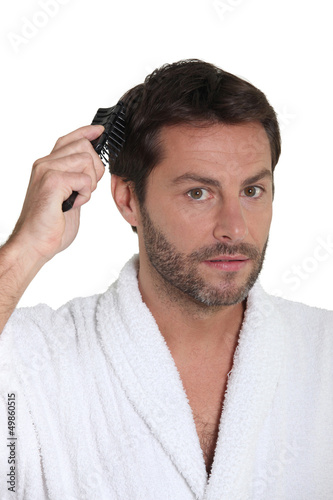 Photo: Man combing hair Man combing hair
