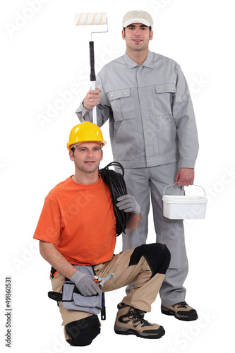 Photo: Electrician kneeling by painter Electrician kneeling by painter