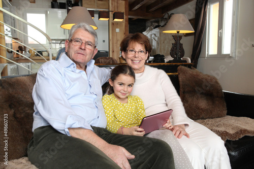 Photo: Grandparents and granddaughter using laptop computer Grandparents and granddaughter using laptop computer