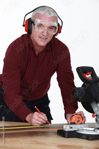 Photo: Man with a rotary saw Man with a rotary saw