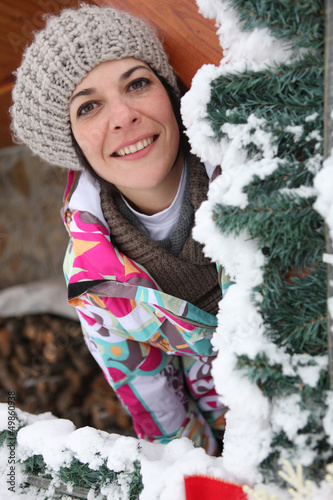 Photo: Woman behind snowy tree Woman behind snowy tree