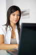 Photo: Brunette doing some work from home Brunette doing some work from home