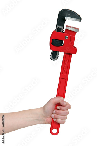 Photo: close-up of female hand holding adjustable spanner close-up of female hand holding adjustable spanner