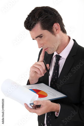 Photo: Man analyzing pie-chart Man analyzing pie-chart