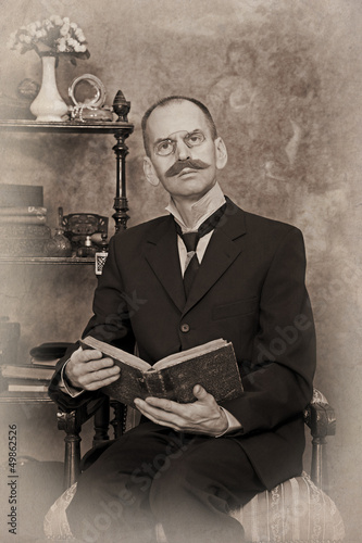 Photo: Sepia portrait of man reading the book Sepia portrait of man reading the book