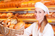Female baker selling bread in her bakery