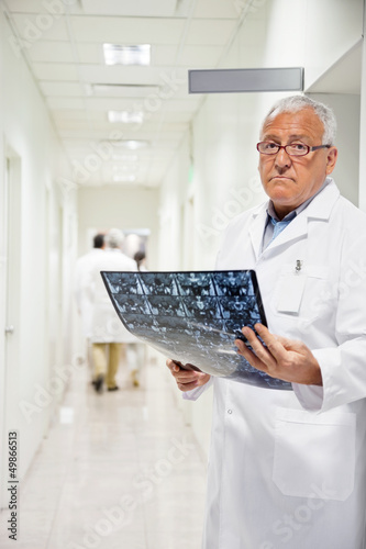 Photo: Radiologist Holding MRI X-ray Radiologist Holding MRI X-ray
