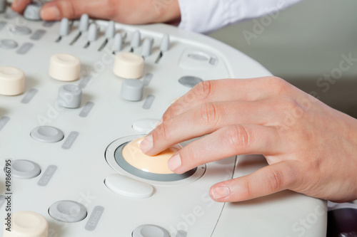 Photo: Female Radiologist Operating Ultrasound Machine Female Radiologist Operating Ultrasound Machine