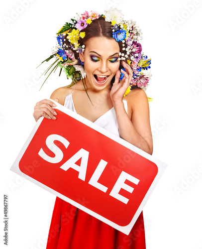 Photo: Woman holding sale banner and flower. Woman holding sale banner and flower.