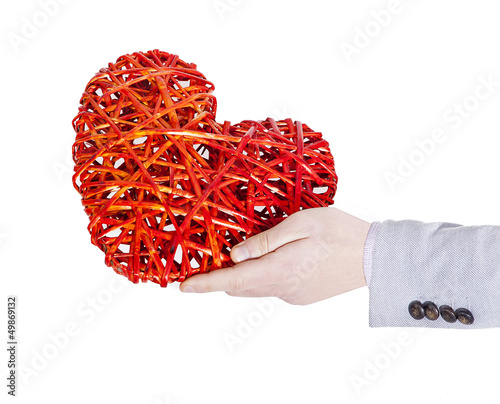 Photo: man who maintains a heart twisted with a hand man who maintains a heart twisted with a hand