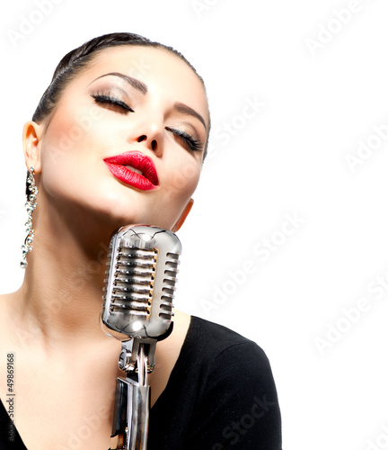 Photo: Singing Woman with Retro Microphone isolated on white Singing Woman with Retro Microphone isolated on white