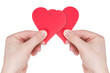Photo: Hands holding two red paper hearts Hands holding two red paper hearts