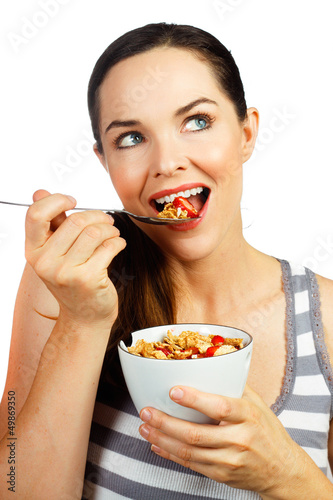 Photo: Healthy woman eating cereal Healthy woman eating cereal